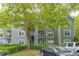 Exterior of the property featuring gray siding, balconies, and well-maintained landscaping and parking at 4106 Santa Fe Pkwy, Atlanta, GA 30350