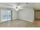 Bright living room features light colored wood floors and a sliding glass door to a balcony at 4106 Santa Fe Pkwy, Atlanta, GA 30350