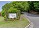 Entrance to Victoria Heights community with sign surrounded by trees, flowers, and landscaping at 4106 Santa Fe Pkwy, Atlanta, GA 30350