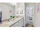 Bright bathroom featuring double sinks, granite countertops, and modern fixtures at 1451 Stephens View Dr, Loganville, GA 30052