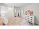 Neutral-toned bedroom offers bright natural light and leads to a walk-in closet at 1451 Stephens View Dr, Loganville, GA 30052