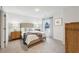 This bedroom has neutral colors and features hardwood furniture, and a window with natural lighting at 1451 Stephens View Dr, Loganville, GA 30052