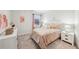 Cozy bedroom with a window, a bed with peach accents, and neutral wall decor at 1451 Stephens View Dr, Loganville, GA 30052