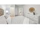 Serene bedroom with a decorative wall hanging, light colors, and ample closet space at 1451 Stephens View Dr, Loganville, GA 30052