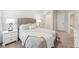 Inviting bedroom with a tufted headboard, plush bedding, and modern bedside lamps at 1451 Stephens View Dr, Loganville, GA 30052