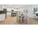Open-concept kitchen with white cabinets, stainless steel appliances, and a blue island with seating for casual dining at 1451 Stephens View Dr, Loganville, GA 30052
