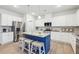 Bright kitchen featuring white cabinets, stainless steel appliances, and a contrasting blue island at 1451 Stephens View Dr, Loganville, GA 30052