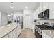 Beautiful kitchen with stainless steel appliances, white cabinets, and granite counters, ideal for cooking and entertaining at 1451 Stephens View Dr, Loganville, GA 30052