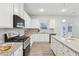 The kitchen offers stainless steel appliances, white cabinets, and granite countertops at 1451 Stephens View Dr, Loganville, GA 30052