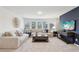 Bright living room with large sectional sofa, big windows, and stylish decor at 1451 Stephens View Dr, Loganville, GA 30052