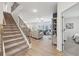 Inviting staircase leading to a spacious living room, offering a comfortable and connected living space at 1451 Stephens View Dr, Loganville, GA 30052