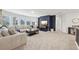 Spacious living room with large windows, a comfortable sofa, and stylish decor in neutral tones at 1451 Stephens View Dr, Loganville, GA 30052