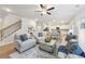 Bright open-concept living space with a view into the modern kitchen, featuring hardwood floors and comfortable seating at 1451 Stephens View Dr, Loganville, GA 30052