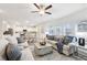 Spacious living room with hardwood floors, comfortable seating, and a seamless transition to the modern kitchen at 1451 Stephens View Dr, Loganville, GA 30052
