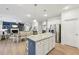 Open concept living area with kitchen island, dining table and comfortable sitting area at 1451 Stephens View Dr, Loganville, GA 30052