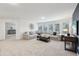 Bright living room with large sectional sofa, big windows, and stylish decor at 1451 Stephens View Dr, Loganville, GA 30052