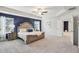 Spacious main bedroom features tray ceilings, a ceiling fan, plush carpeting, and a large picture window at 1451 Stephens View Dr, Loganville, GA 30052