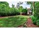 Expansive backyard with lush greenery, a well-maintained lawn, and mulch beds, creating a private outdoor oasis at 2639 Acorn Ne Ave, Atlanta, GA 30305