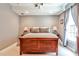 Cozy bedroom with a wooden bed frame, soft lighting, and neutral-toned walls at 2639 Acorn Ne Ave, Atlanta, GA 30305
