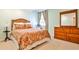 Bedroom featuring a patterned bedspread, wood furniture, and ample natural light at 2639 Acorn Ne Ave, Atlanta, GA 30305