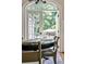 Close up of breakfast nook with French doors opening to an outdoor seating area in a lush, wooded setting at 2639 Acorn Ne Ave, Atlanta, GA 30305