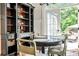 Bright breakfast nook featuring built-in shelving, table for four, and French doors leading to outdoor space at 2639 Acorn Ne Ave, Atlanta, GA 30305