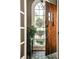 Inviting entryway with a dark stained wood front door, large arched window, and a view of the front yard at 2639 Acorn Ne Ave, Atlanta, GA 30305