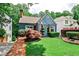Charming home featuring well-manicured front yard with lush landscaping and a brick walkway leading to the front entrance at 2639 Acorn Ne Ave, Atlanta, GA 30305