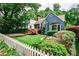 Charming home with a manicured lawn, mature trees, and a white picket fence, creating a welcoming curb appeal at 2639 Acorn Ne Ave, Atlanta, GA 30305