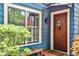 Charming home exterior with a wood door, window box, well-manicured landscaping, and an American flag at 2639 Acorn Ne Ave, Atlanta, GA 30305