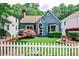 Charming blue two-story home with a manicured lawn, lovely landscaping, and a classic white picket fence at 2639 Acorn Ne Ave, Atlanta, GA 30305
