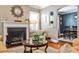 Cozy living room featuring a fireplace, hardwood floors, and views of the dining area at 2639 Acorn Ne Ave, Atlanta, GA 30305