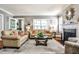 Bright living room with hardwood floors, elegant fireplace, neutral walls, and comfortable seating arrangement at 2639 Acorn Ne Ave, Atlanta, GA 30305