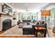 Spacious living room with fireplace, built-in shelving, hardwood floors, and multiple windows for natural light at 2639 Acorn Ne Ave, Atlanta, GA 30305