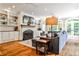 Bright living room boasts fireplace, built-ins, hardwood floors and large windows for an airy feel at 2639 Acorn Ne Ave, Atlanta, GA 30305