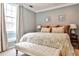 Serene main bedroom featuring a king-size bed, neutral color palette, and ample natural light from a large window at 2639 Acorn Ne Ave, Atlanta, GA 30305