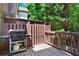 Backyard deck featuring a grill surrounded by greenery and a wooden fence at 5439 Alanis Se Pl # 17, Mableton, GA 30126