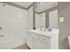 Bright bathroom with a white tiled shower and a large vanity at 5439 Alanis Se Pl # 17, Mableton, GA 30126