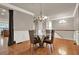 Dining room showcasing a chandelier, wainscoting, and a glass table with four chairs at 5439 Alanis Se Pl # 17, Mableton, GA 30126