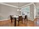 Dining room featuring hardwood floors, large windows, and a modern chandelier at 5439 Alanis Se Pl # 17, Mableton, GA 30126