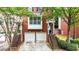 Charming brick townhome featuring a two-car garage and inviting entrance with landscaped surroundings at 5439 Alanis Se Pl # 17, Mableton, GA 30126