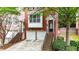 Charming brick townhome showcasing a two-car garage, and inviting entrance surrounded by greenery at 5439 Alanis Se Pl # 17, Mableton, GA 30126
