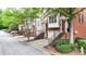 Brick townhomes with garages, inviting entrances, and greenery on a tree lined street at 5439 Alanis Se Pl # 17, Mableton, GA 30126