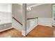 Bright foyer area with hardwood floors, white wainscoting, staircase, and natural light at 5439 Alanis Se Pl # 17, Mableton, GA 30126
