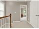 Upper hallway with neutral walls, carpet, and a view into a bedroom at 5439 Alanis Se Pl # 17, Mableton, GA 30126