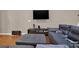 Comfortable living room area featuring a large television and grey sectional seating at 5439 Alanis Se Pl # 17, Mableton, GA 30126
