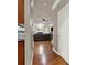 Hallway leading to a living room with a fireplace, ceiling fan, and hardwood floors at 5439 Alanis Se Pl # 17, Mableton, GA 30126