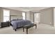 Main bedroom boasts tray ceiling, carpet, and a dark wood bench at 5439 Alanis Se Pl # 17, Mableton, GA 30126