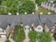 Aerial view of townhome community featuring well-maintained landscaping and ample parking at 7077 Biltmore Trce, Lithonia, GA 30058