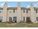Townhome backyard, featuring a patio with outdoor seating, and green space at 7077 Biltmore Trce, Lithonia, GA 30058